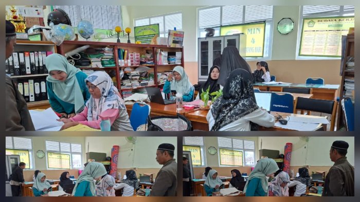 Guru MIN 4 Batang Hari Sedang Mengoreksi Hasil Ujian Semester
